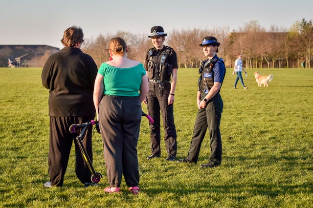 Police chat to people in a park