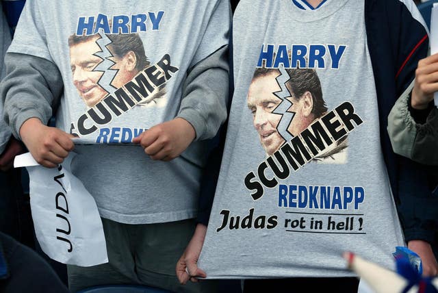 Two Portsmouth fans wear 'Scummer' T-shirts relating to former manager Harry Redknapp's move to Southampton