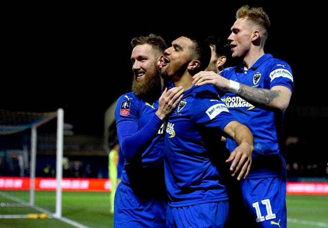 AFC Wimbledon celebrate against West Ham in the FA Cup. (PA)