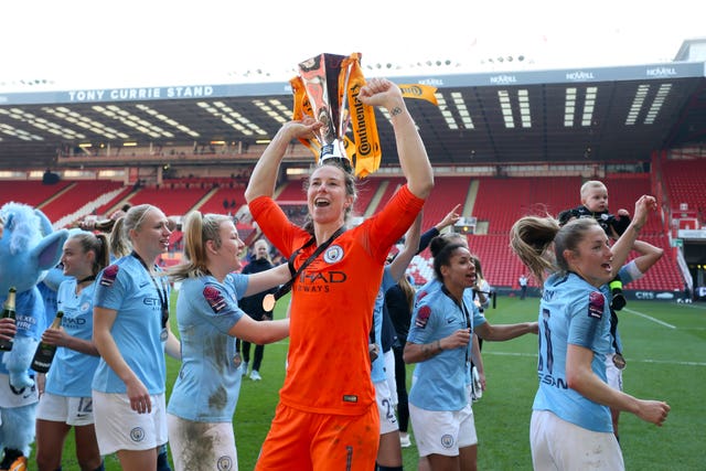 Manchester City goalkeeper Karen Bardsley lifts the trophy after her side's win 