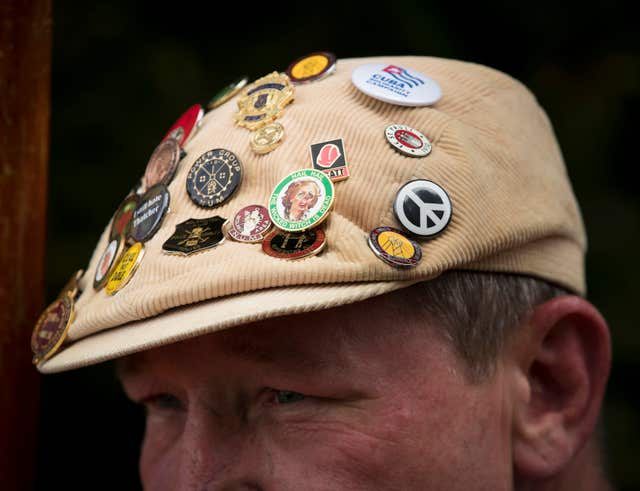 An activist's badge-covered flat cap