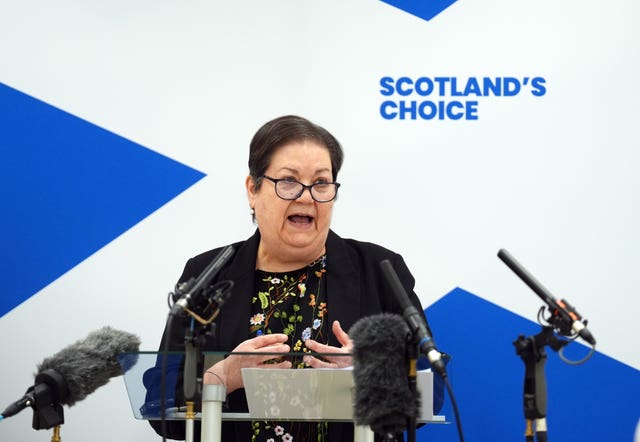 Dane Jackie Baillie speaking from a lectern, in front of a sign which reads 'Scotland's choice'
