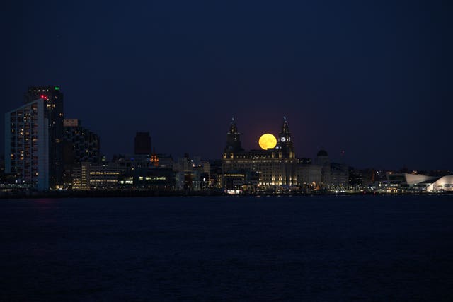 The Sturgeon supermoon, the final supermoon of the year, rises over the Royal Liver Building in Liverpool
