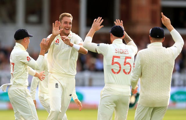 Stuart Broad celebrates with his team-mates after removing David Warner at Lord's