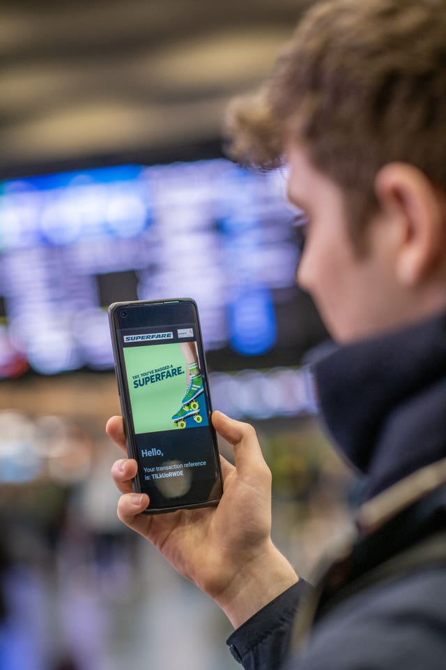 A person booking a train ticket using the scheme