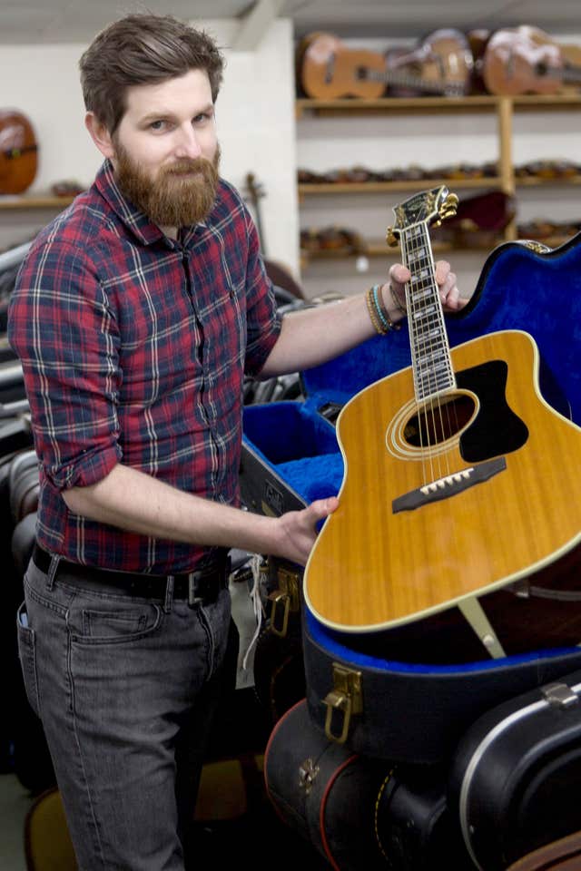 Luke Hobbs holding a guitar owned by Eric Clapton (Clare Hobbs Photography/Gardiner/PA)