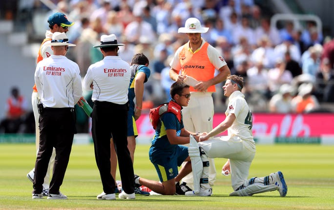 Steve Smith receives treatment to his arm after a brutal Jofra Archer delivery