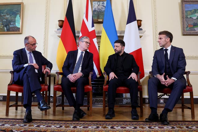 Friedrich Merz, Sir Keir Starmer, Volodymyr Zelensky and Emmanuel Macron sit in front of their respective nations' flags in 10 Downing Street
