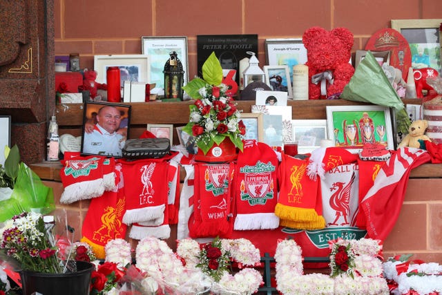 Flowers and tributes left at the Hillsborough Memorial outside Anfield stadium, Liverpool, following the collapse of the trial in May
