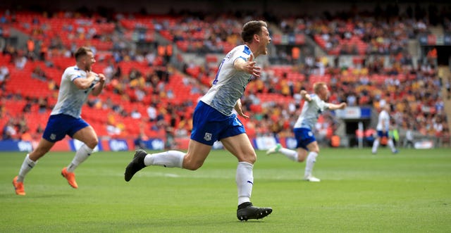 Connor Jennings wheels away in delight after netting the winner at Wembley