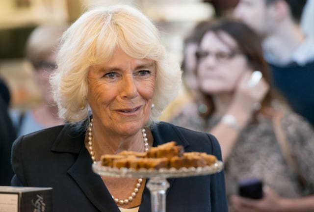 The Duchess of Cornwall at a bakery stall during a visit to Carmarthen Market to meet market traders and stall holders, including Richardson’s Bakery, who made cakes for her wedding reception in 2005. Richard Stonehouse/PA Wire