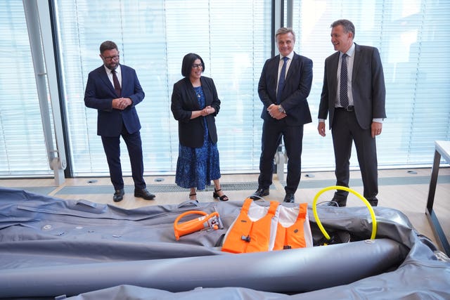 Shabana Mahmood, alongside Rob Jones (left), director general of operations, and members of NCA staff, with equipment seized by NCA