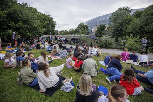 Taylor Swift fans outside the Aviva Stadium listen in to the concert