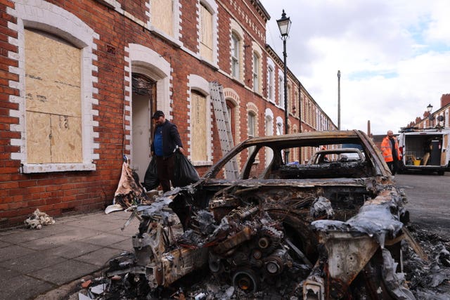 Burned-out cars and boarded-up houses on McMaster Street in east Belfast after the violence