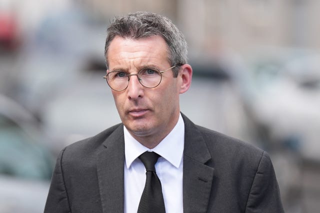 Agriculture Minister Andrew Muir looks at the camera