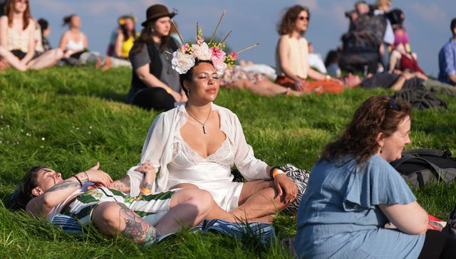 A woman meditates during the Bealtaine Fire Festival at the Hill of Uisneach in Co Westmeath