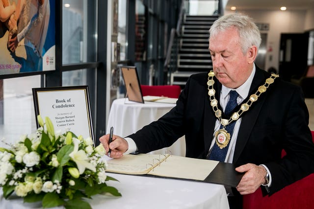 Councillor Sean McPeake, chairman of Mid-Ulster District Council, signing a book of condolence in Cookstown