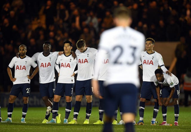 Tottenham''s players wait as Christian Eriksen walks back after missing his penalty 