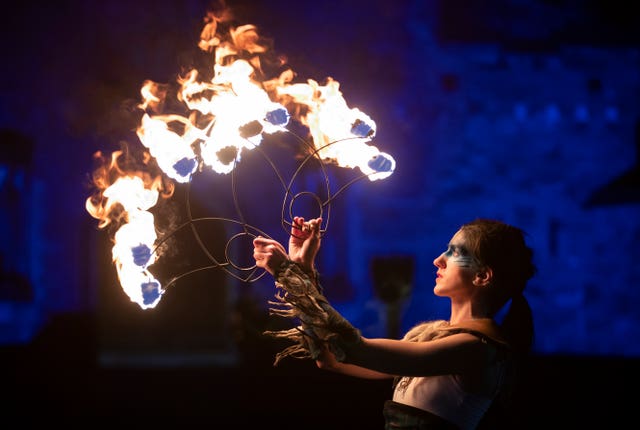 A fire juggler performs