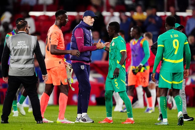 England manager Thomas Tuchel, centre left, congratulates Senegal’s Idrissa Gueye