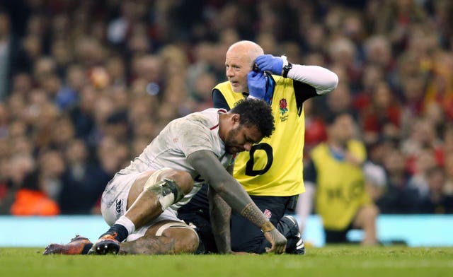 England’s Courtney Lawes receives treatment for an injury in Cardiff