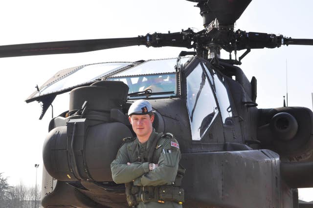 Prince Harry standing in front of his Apache Helicopter (Clarence House/PA)