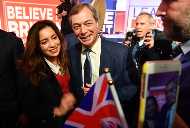 Nigel Farage poses for photos with a supporter at a Leave Means Leave 'Save Brexit' rally
