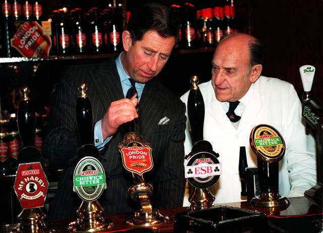 Charles pulling a pint of London Pride bitter in 1995