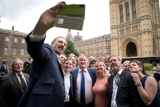 SNP MP Chris Law takes a selfie alongside his party's Westminster leader Ian Blackford outside Parliament after the Commons protest (Stefan Rousseau/PA)
