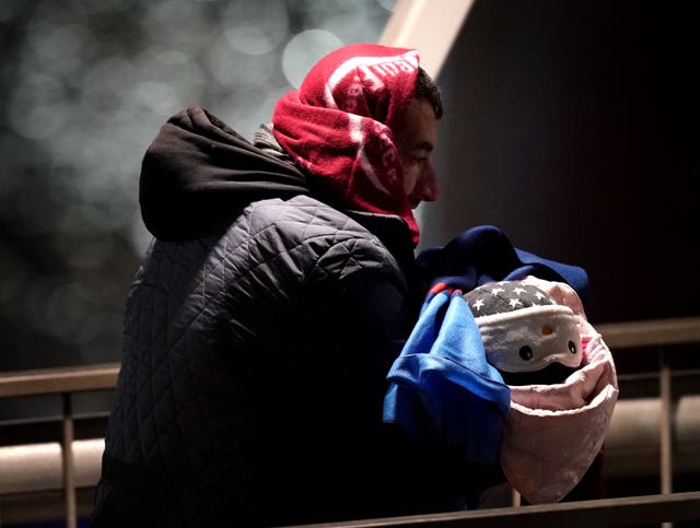 A man carries a baby