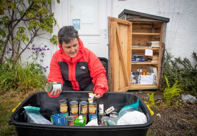 Becs Barker checks the donations left in the “swap shop” box