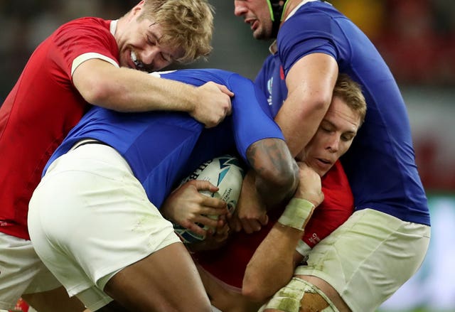 Liam Williams, right, is tackled during the World Cup quarter-final against France