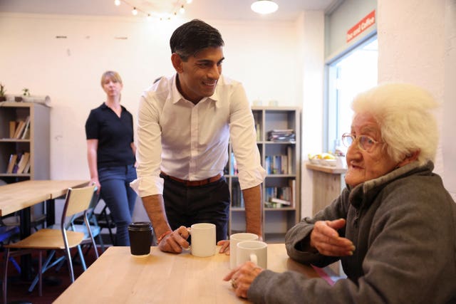 Prime Minister Rishi Sunak meets Christine Tadgell, 77, a member of the community attending a breakfast club at Wormley Community Centre in Hertfordshire