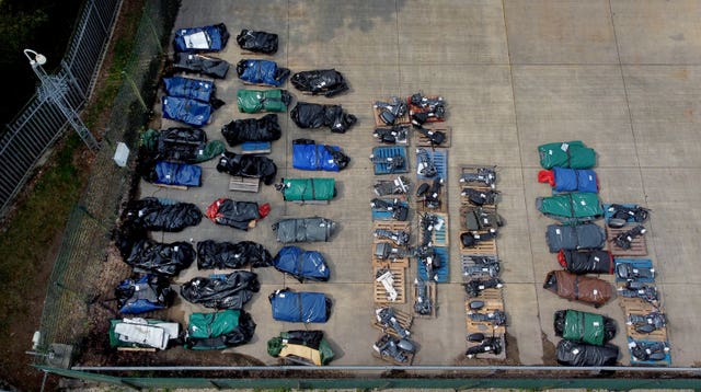 Small boats and engines in storage after being used to cross the Channel