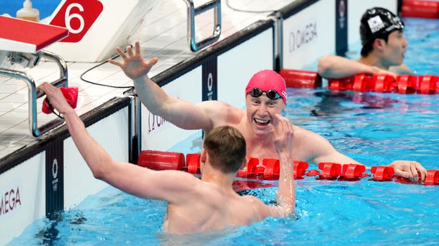 Tom Dean celebrates with Great Britain team-mate Duncan Scott
