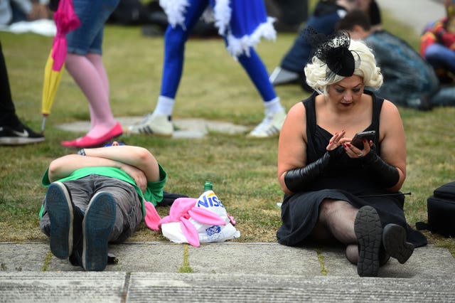 Cos players sitting on grass