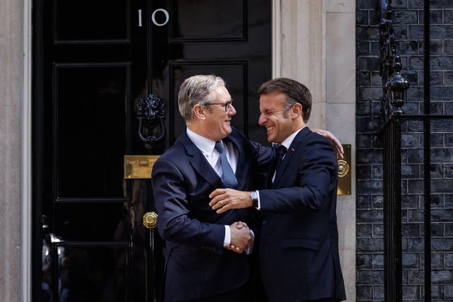 Sir Keir Starmer (left) and Emannuel Macron embrace outside 10 Downing Street