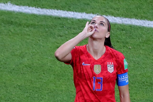 Morgan made a tea-drinking gesture as she celebrated scoring against England last year (Richard Sellers/PA).