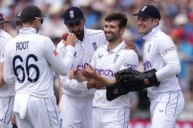 Mark Wood, second right, celebrates a wicket