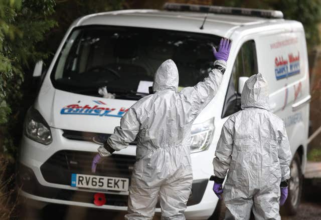 Investigators in protective clothing remove a van from an address in Winterslow (Andrew Matthews/PA)