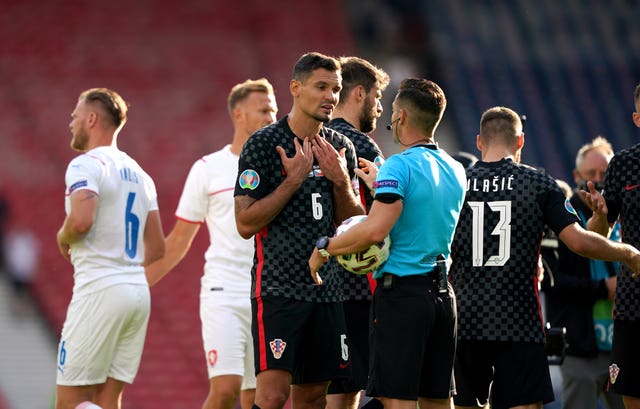 Dejan Lovren questions the referee