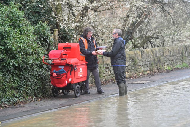 Man helps postman deliver through floods