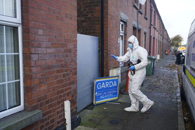 A gardai coroner searches a house in Dundalk, Co Louth, as part of an investigation into the suspected murder of eight-year-old Kyran Durnin