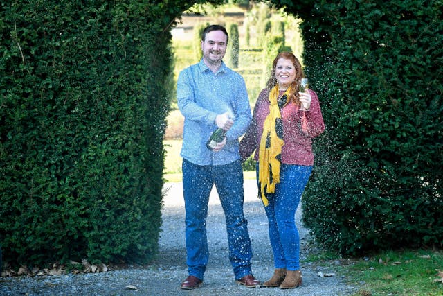 The couple toast their win win champagne