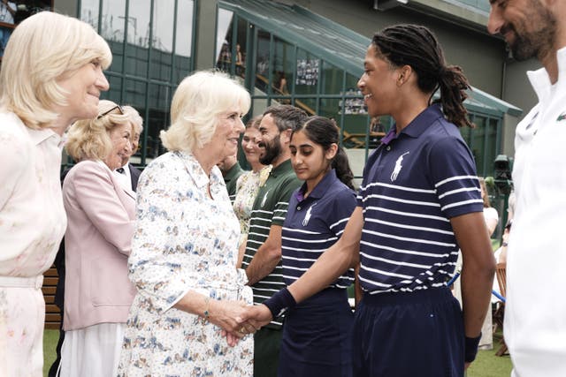 The Queen speaks to ball boy Karsten at the All England Lawn Tennis and Croquet Club on day 10 of the 2025 Wimbledon Championships