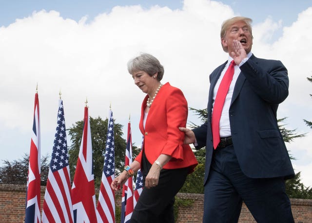 US President Donald Trump walking with Prime Minister Theresa May prior to a joint press conference at Chequers, her country residence in Buckinghamshire