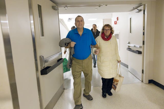Tim Andrews with his wife Karen walk out of hospital