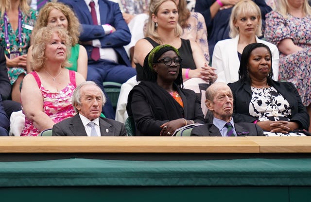 Former Formula One world champion Sir Jackie Stewart, left, watches the action