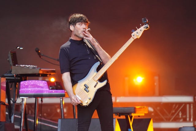 Alex James playing his bass