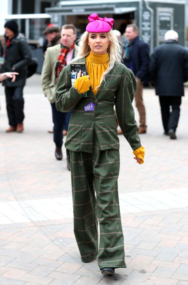 A racegoer arrives ahead of Ladies Day of the 2019 Cheltenham Festival at Cheltenham Racecourse.